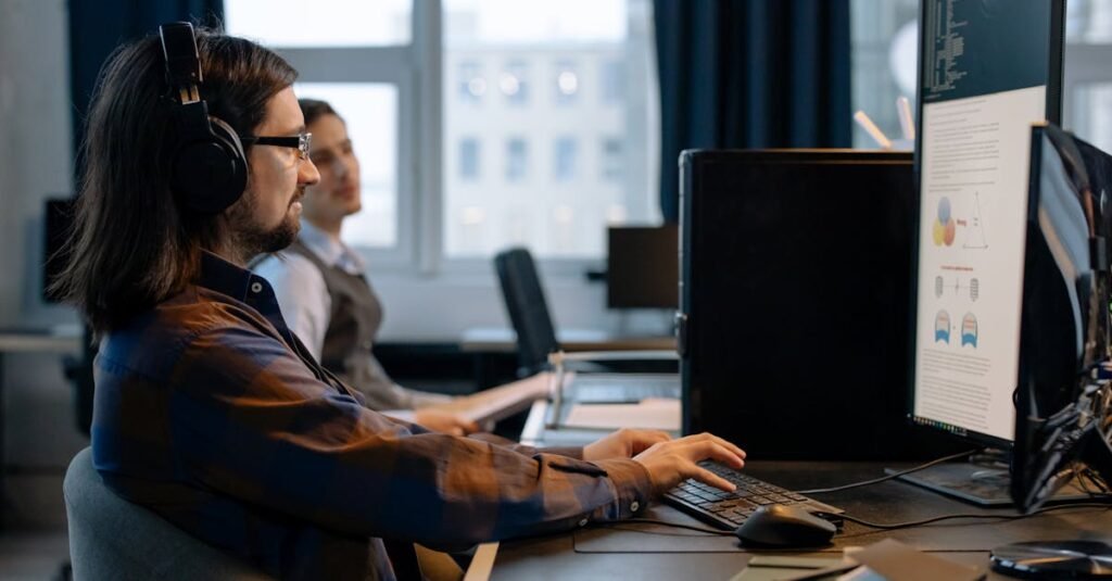 Two programmers working together with focus on coding in a modern, tech-savvy office environment.